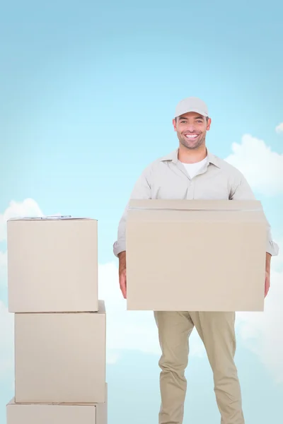 Correio homem transportando caixa de papelão — Fotografia de Stock