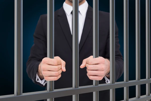 Composite image of businessman in prison — Stok fotoğraf