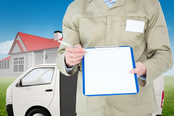 Delivery man showing blank paper on clipboard — Stock Photo, Image