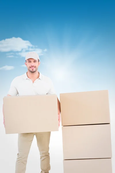 Delivery man holding cardboard box — Stock Photo, Image