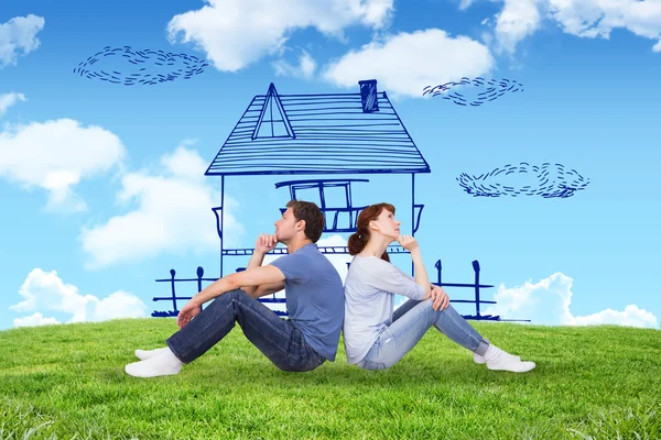 Composite image of couple sitting on floor together — Stock Photo, Image