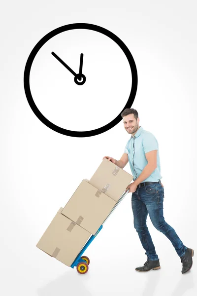 Delivery man pushing trolley of boxes — Stock Photo, Image