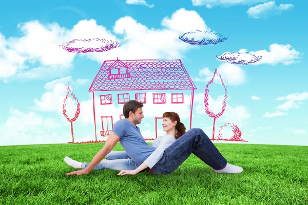 Composite image of couple sitting on the floor — Stock Photo, Image