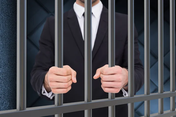 Composite image of businessman in prison — 图库照片