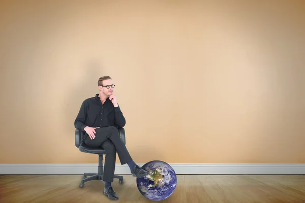 Thoughtful businessman sitting on a swivel chair — Stock Photo, Image