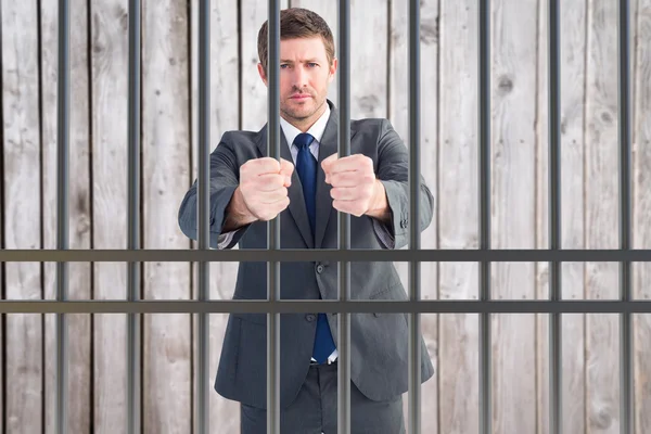 Composite image of businessman in prison — Stock Fotó