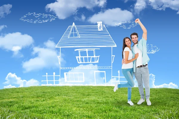 Happy casual couple cheering at camera — Stock Photo, Image