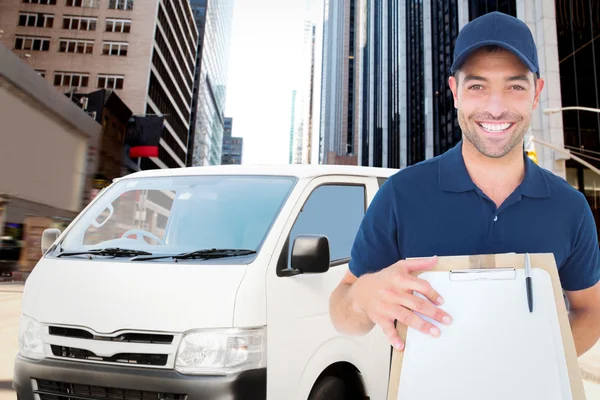 Happy delivery man with package and clipboard — Stock Photo, Image