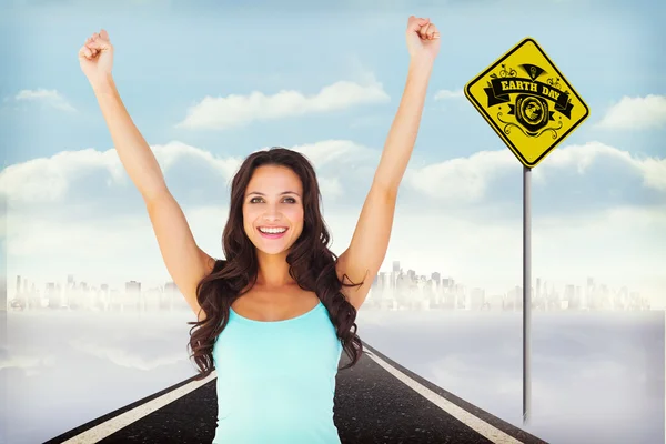 Composite image of casual brunette cheering at camera — Stock Photo, Image