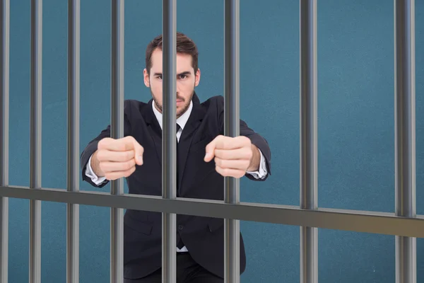 Composite image of businessman in prison — Stok fotoğraf