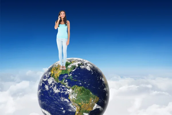 Brunette on the phone against blue sky over clouds — Φωτογραφία Αρχείου