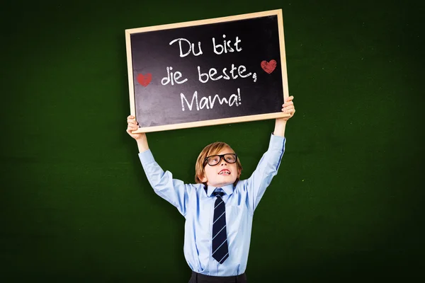 Composite image of cute pupil holding chalkboard — Stock Photo, Image