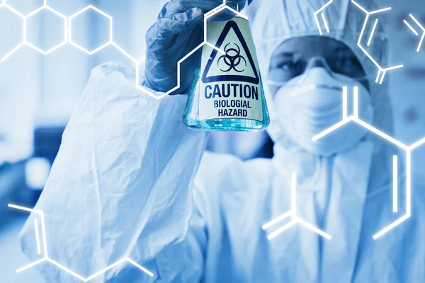 Scientist in protective suit with hazardous chemical — Stockfoto