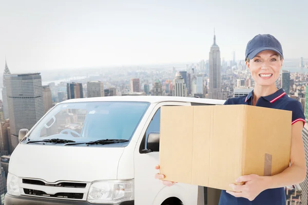 Happy delivery woman holding cardboard box — Stock Photo, Image