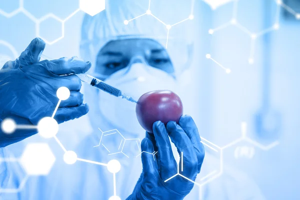 Researcher in protective suit injecting tomato at lab — Stock Photo, Image