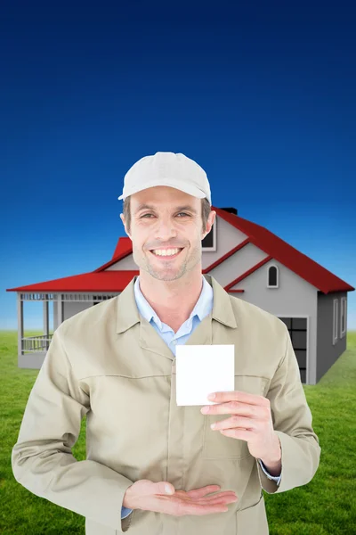 Happy delivery man showing blank note — Stock Photo, Image