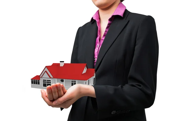 Businesswomans holding hands out against 3d house — Stock Photo, Image