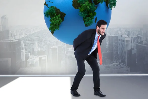 Businessman carrying the world — Stock Photo, Image