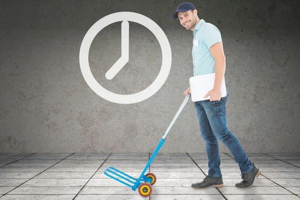 Delivery man pushing empty trolley — Stock Photo, Image