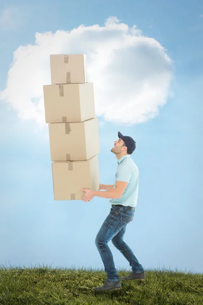 Delivery man carrying stack of boxes — Stock Photo, Image