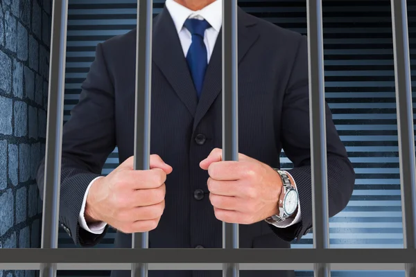 Composite image of businessman in prison — Stock fotografie