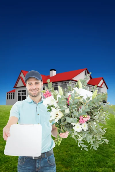 Composite image of flower delivery man showing clipboard — Stock Photo, Image