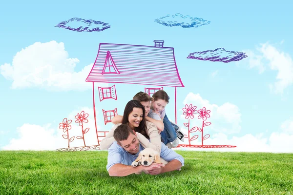 Composite image of happy family with puppy — Stock Photo, Image