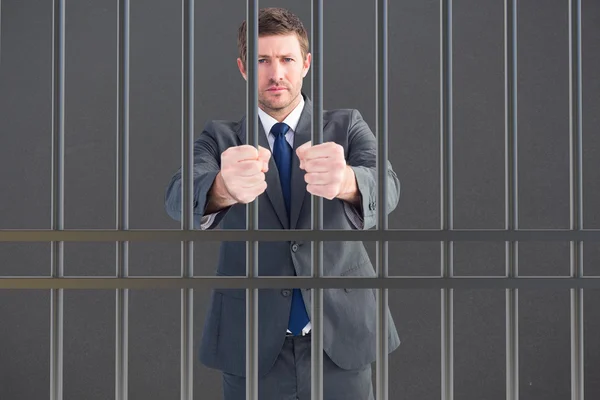 Композитный имидж бизнесмена в тюрьме — стоковое фото