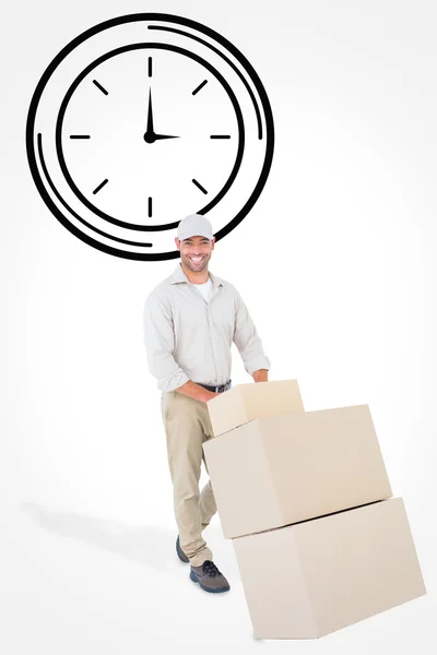 Delivery man pushing trolley of boxes — Stock Photo, Image