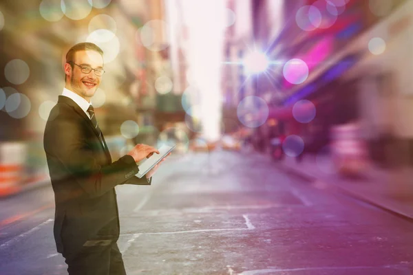 Sammansatt bild av glad affärsman med sin TabletPC — Stockfoto