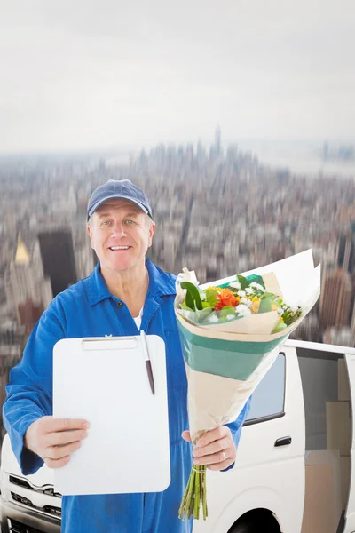 Happy flower delivery man showing clipboard — Stock Photo, Image