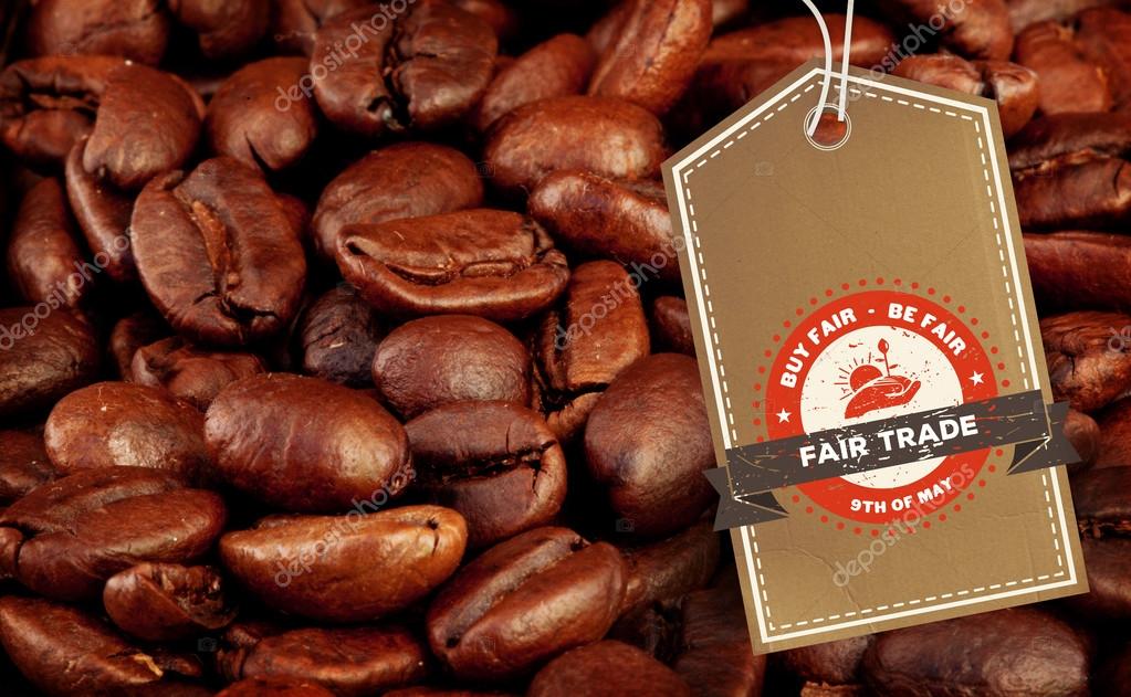 Fair Trade graphic against coffee seeds laid out together