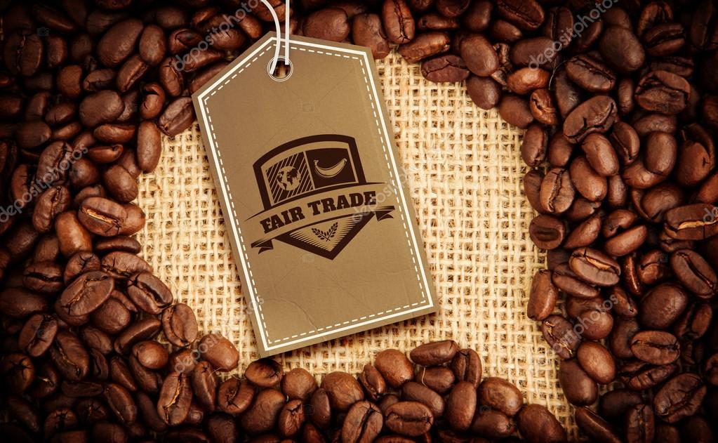 Fair Trade graphic against coffee beans with speech bubble indent for copy space
