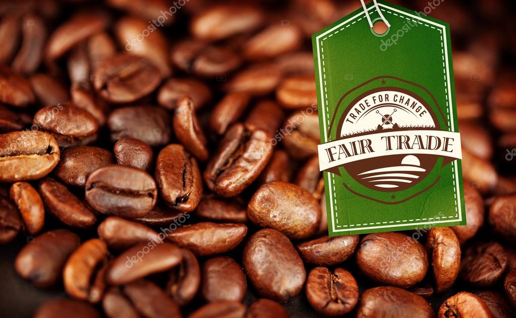 Fair Trade graphic against beans of coffee laid out together