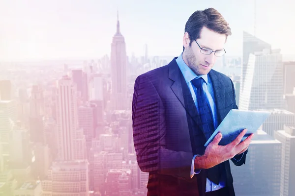 Composite image of businessman using a tablet computer — Stock Photo, Image