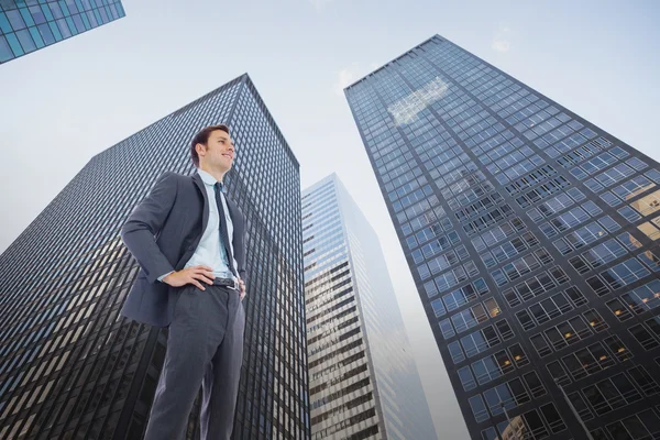 Happy businessman with hands on hips — Stock Photo, Image