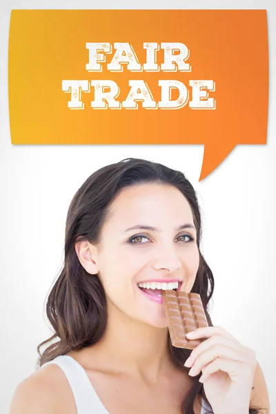 Composite image of pretty brunette eating bar of chocolate — Stock Photo, Image