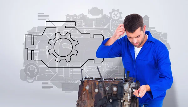 Confused mechanic repairing car engine — Stock Photo, Image