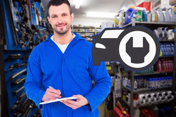 Male mechanic writing on clipboard — Stock Photo, Image