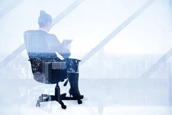 Businesswoman sitting on swivel chair with tablet — Stock Photo, Image