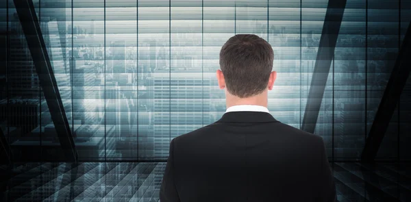 Composite image of  businessman looking in front of him in suit — Stock fotografie