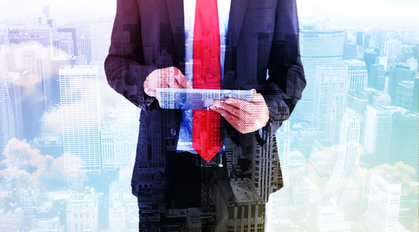 Composite image of businessman scrolling on his digital tablet — Stock Photo, Image