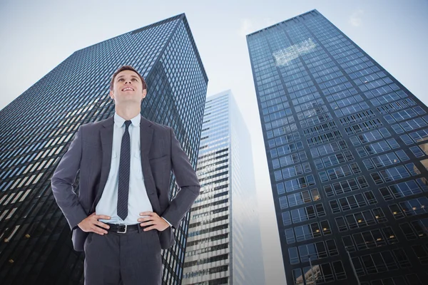 Smiling businessman with hands on hips — Stock Photo, Image