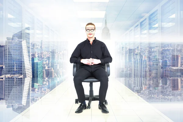 Stern businessman sitting on an office chair — Stock Photo, Image