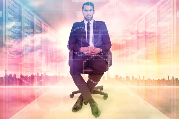 Stern businessman sitting on an office chair — Stock Photo, Image