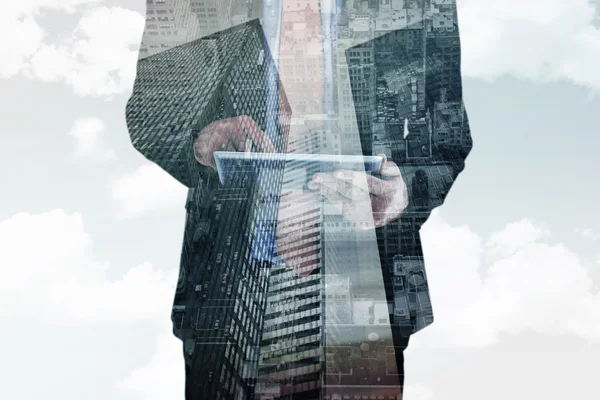 Composite image of businessman scrolling on his digital tablet — Stock Photo, Image