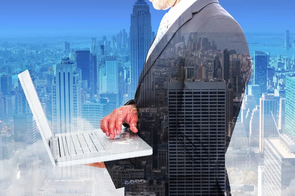 Sammansatt bild av affärsmannen hålla laptop — Stockfoto