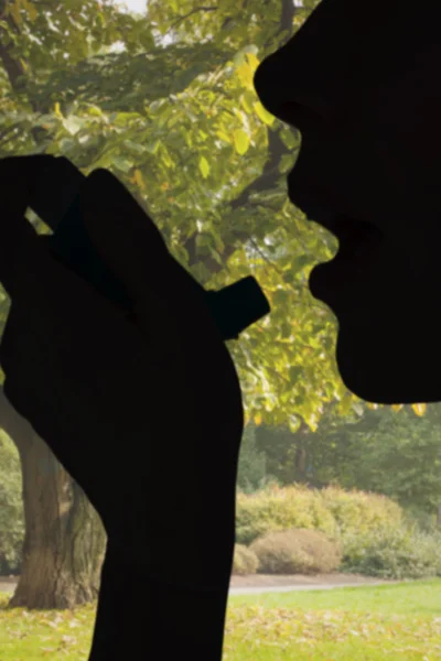 Close up of a woman using an asthma inhaler — Stock Photo, Image