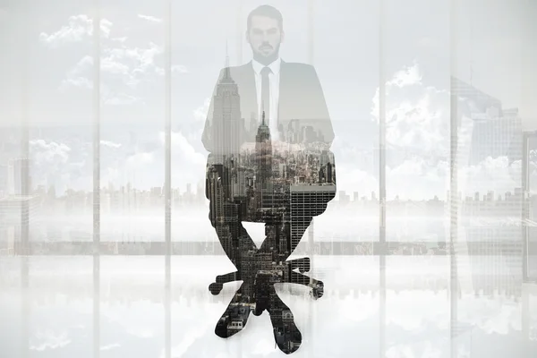 Stern businessman sitting on an office chair — Stock Photo, Image