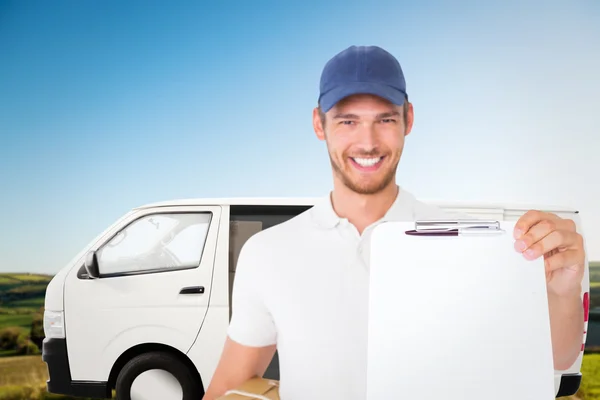 Happy delivery man holding cardboard box — Stock Photo, Image